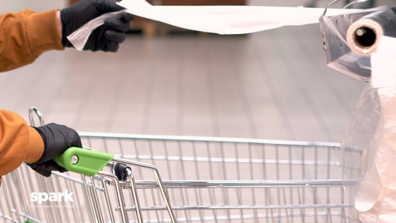 Shopper cleaning trolly in store COVID