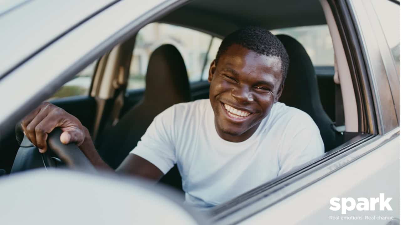 Man driving brand new car after buying it