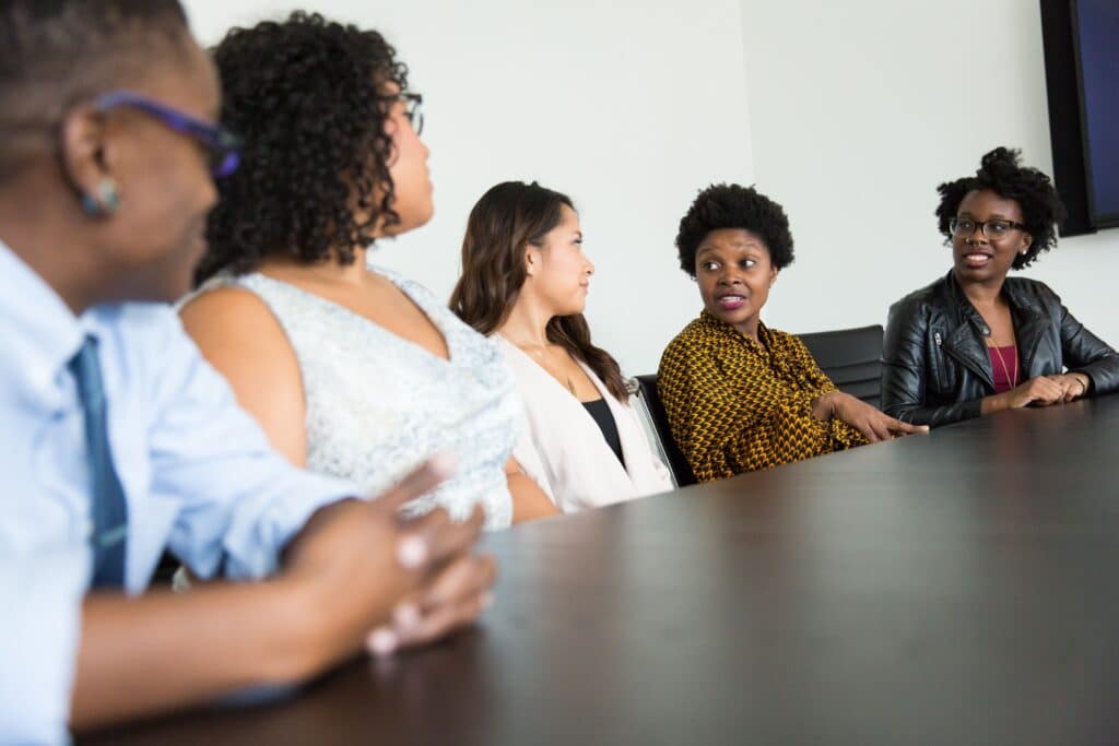 A traditional focus group setting with participants sitting around a meeting table discussing consumer insights