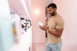 A shopper naturally interacting with a product in a shop, representing human-centred market research consultancies in the UK.