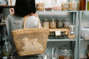 A shopper comparing food products in a store, whilst considering sustainable purchasing choices