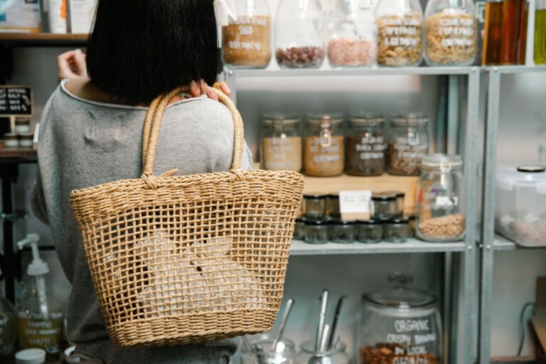 A shopper comparing food products in a store, whilst considering sustainable purchasing choices