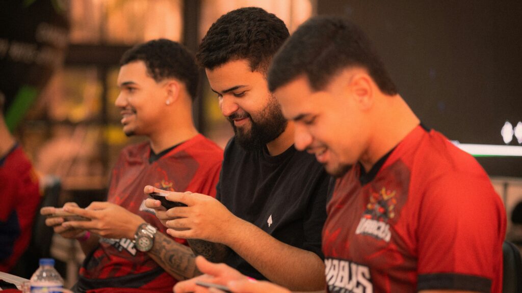 A person deeply engaged in playing a handheld video game console, illustrating the automatic habits and behavioural science behind free to play gaming.