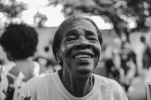 A close-up portrait of a woman smiling genuinely, representing the authentic human feelings measured by the Spark Emotional Wheel to quantify consumer emotions.