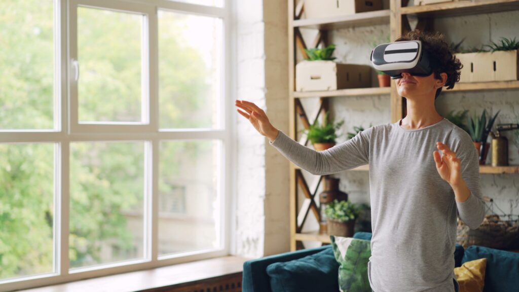 A person wearing a virtual reality headset at home, demonstrating remote audience participation and immersive digital festival access.